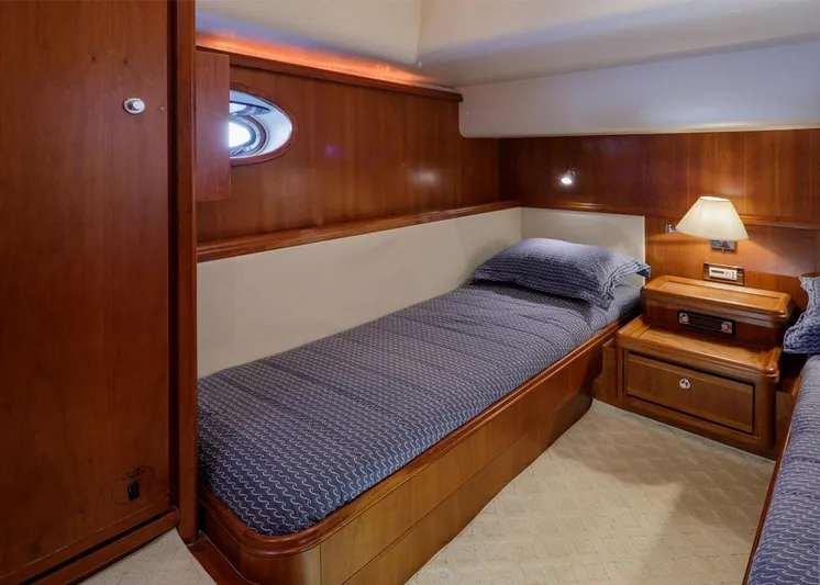  Yacht Photos Pics 2006 Bertram 570 yacht cabin with twin beds and wooden interior.