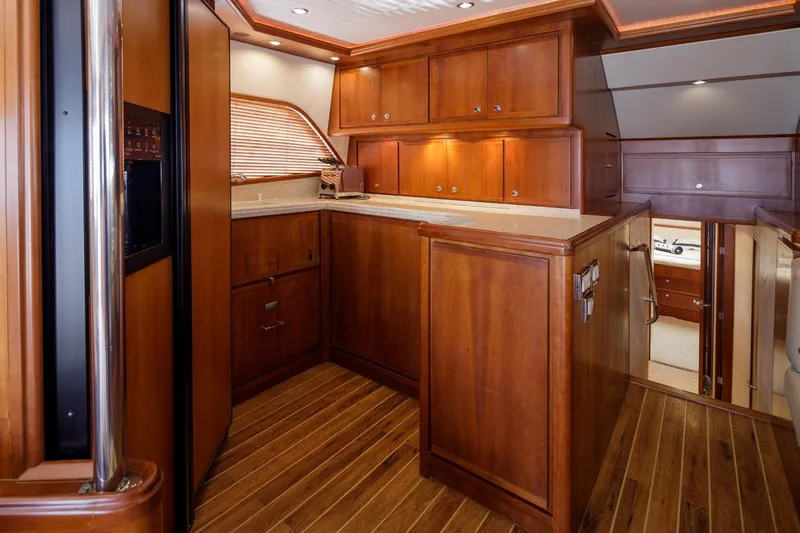  Yacht Photos Pics Luxurious wooden interior of a 2006 Bertram 570 yacht kitchen.