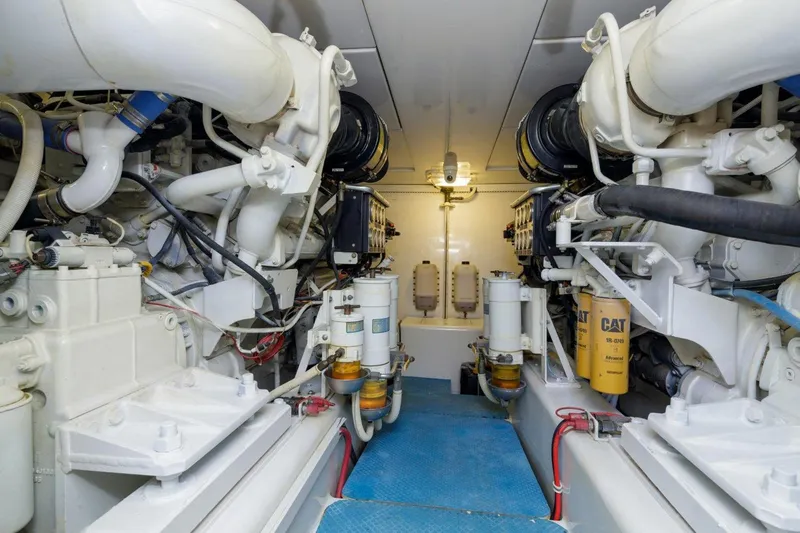  Yacht Photos Pics Engine room of a 2006 Bertram 570 yacht, featuring dual engines and mechanical components.