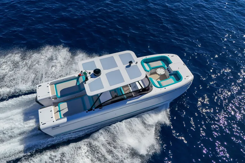  Yacht Photos Pics 2025 Canados Heritage 36 yacht cruising on open blue sea, aerial view.