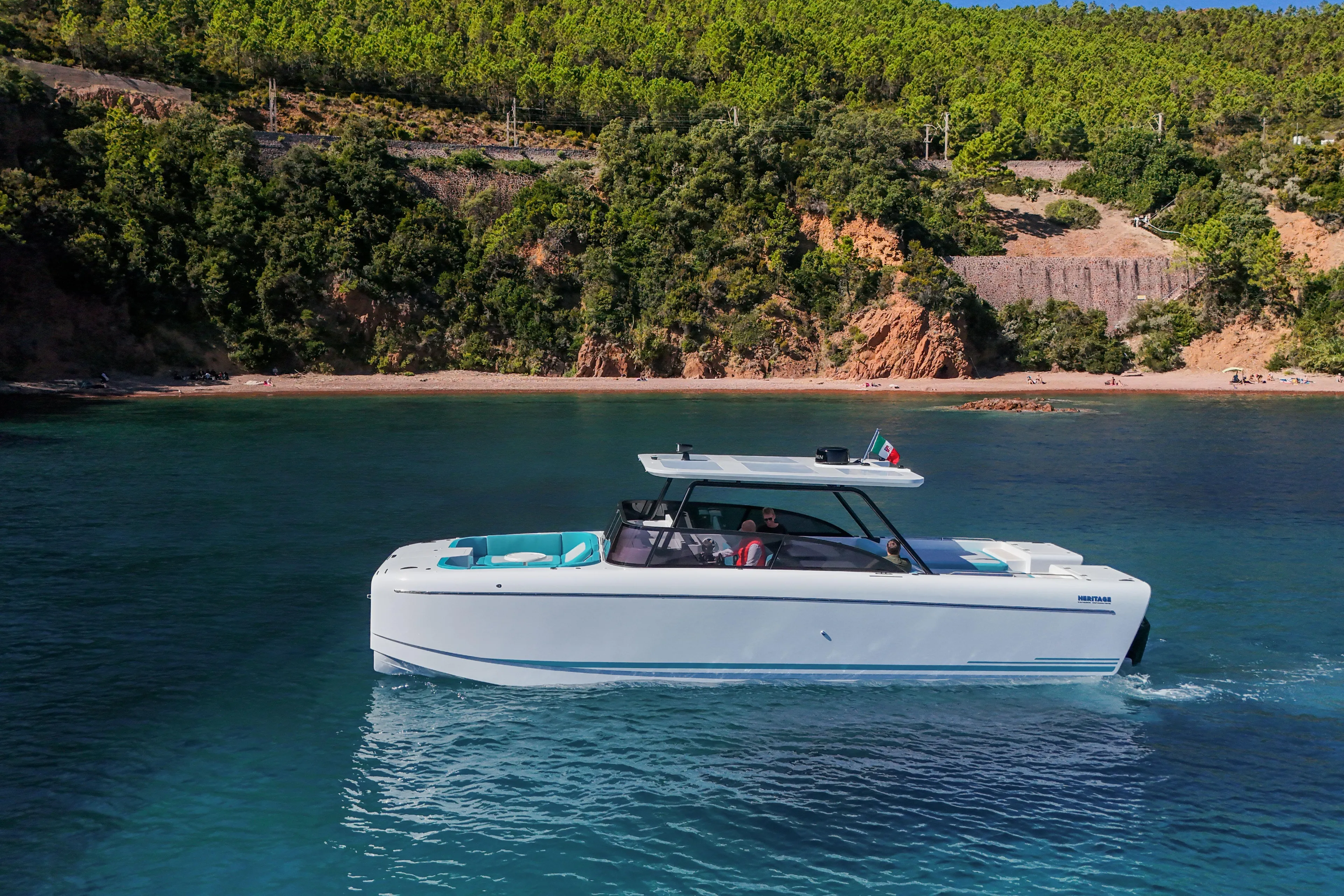  Yacht Photos Pics 2025 Canados Heritage 36 yacht cruising near a scenic, forested coastline.