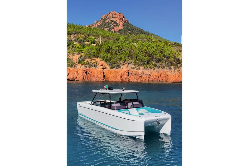  Yacht Photos Pics 2025 Canados Heritage 36 yacht in scenic coastal waters with rocky cliffs.