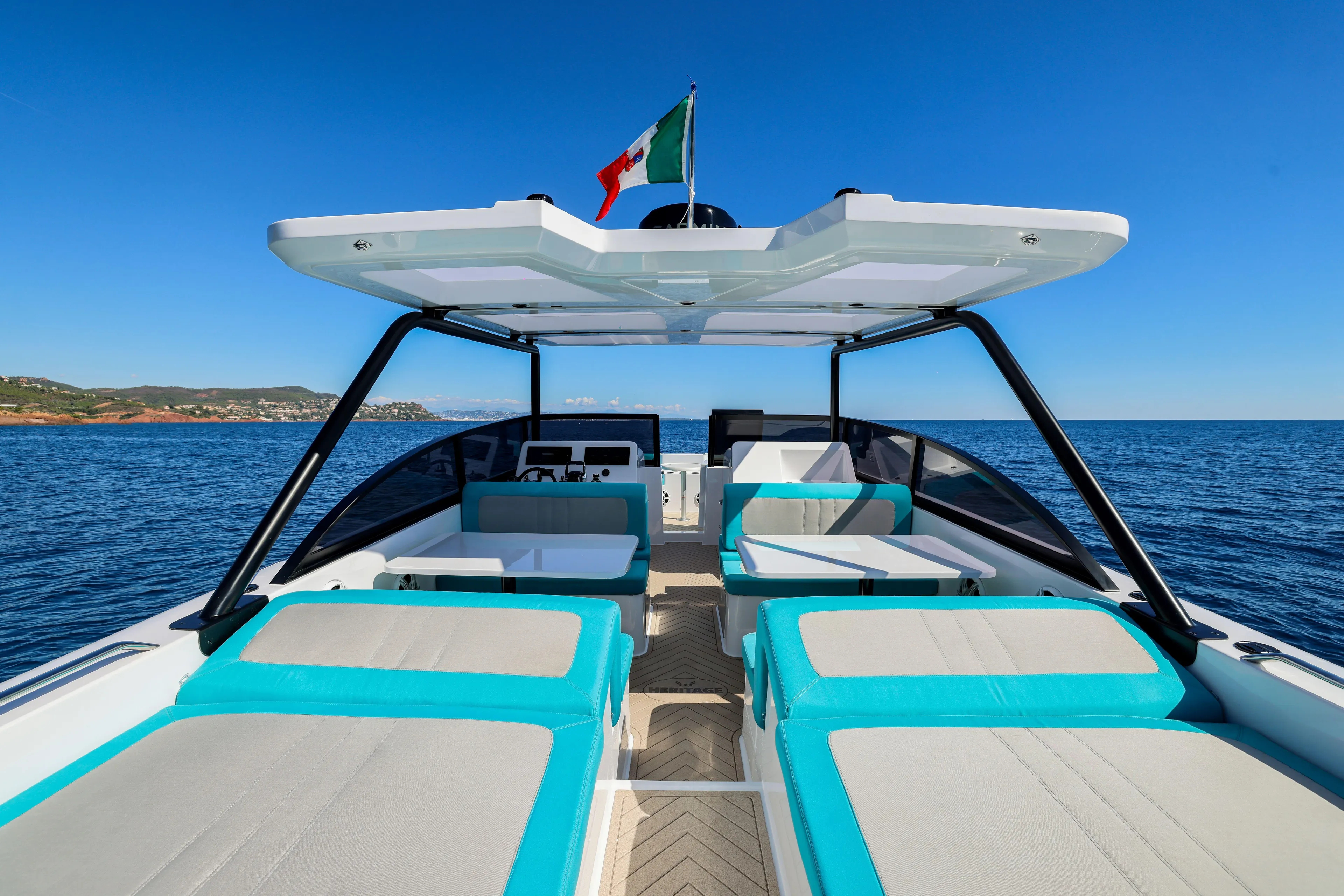  Yacht Photos Pics 2025 Canados Heritage 36 yacht with modern seating, cruising on a clear blue sea.