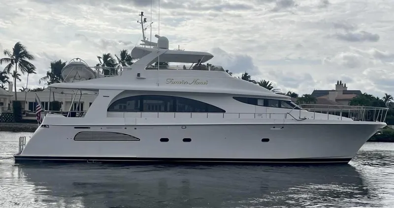 Fancier Nanci Yacht Photos Pics 2002 Cheoy Lee Sport Motor Yacht on calm water, surrounded by palm trees.