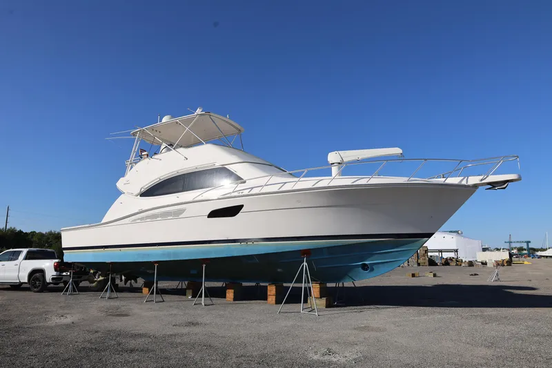  Yacht Photos Pics 2012 Bertram 511 yacht on stands, parked outdoors under clear blue sky.