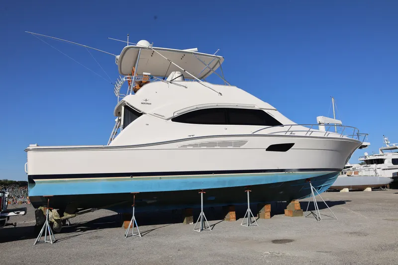  Yacht Photos Pics 2012 Bertram 511 yacht on stands, clear sky background.
