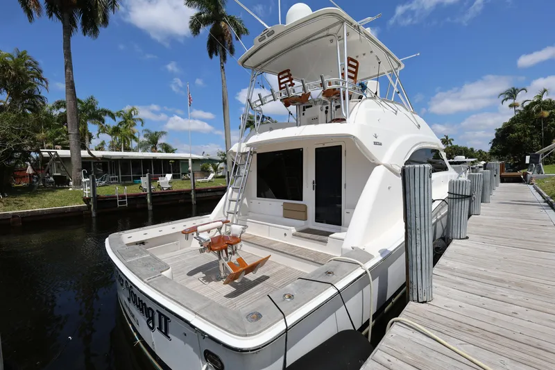  Yacht Photos Pics 2012 Bertram 511 yacht docked, featuring spacious deck and flybridge under clear blue sky.