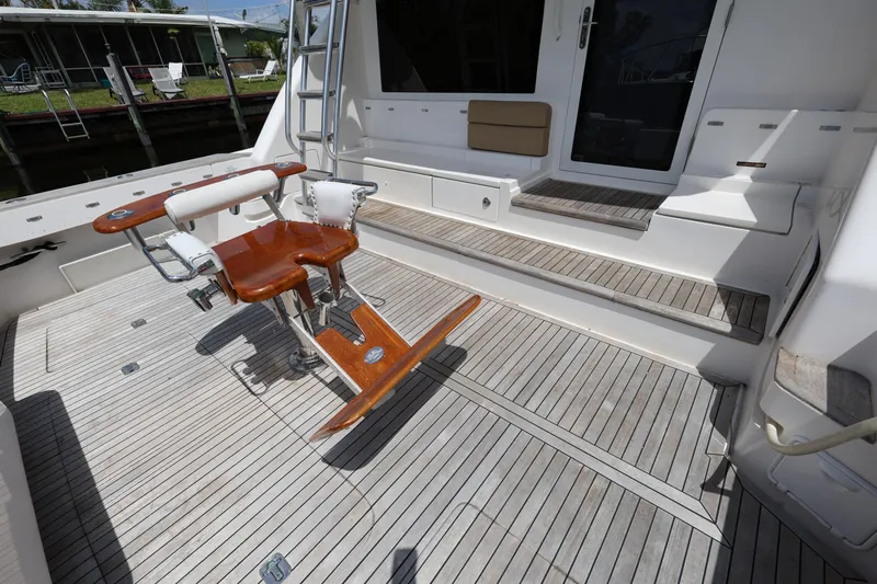  Yacht Photos Pics 2012 Bertram 511 yacht deck with wooden chair and steps.