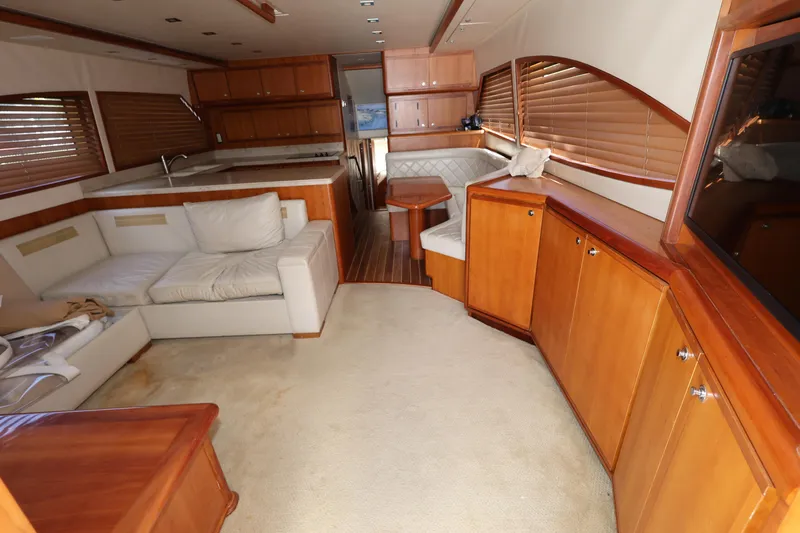  Yacht Photos Pics Luxurious interior of a 2012 Bertram 511 yacht with wooden cabinetry and plush seating.