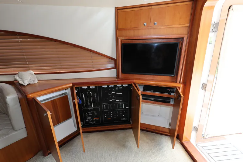  Yacht Photos Pics Interior of 2012 Bertram 511 yacht with wooden cabinetry and entertainment system.