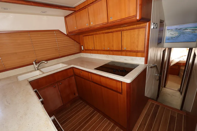  Yacht Photos Pics Luxurious 2012 Bertram 511 yacht kitchen with wooden cabinetry and modern appliances.