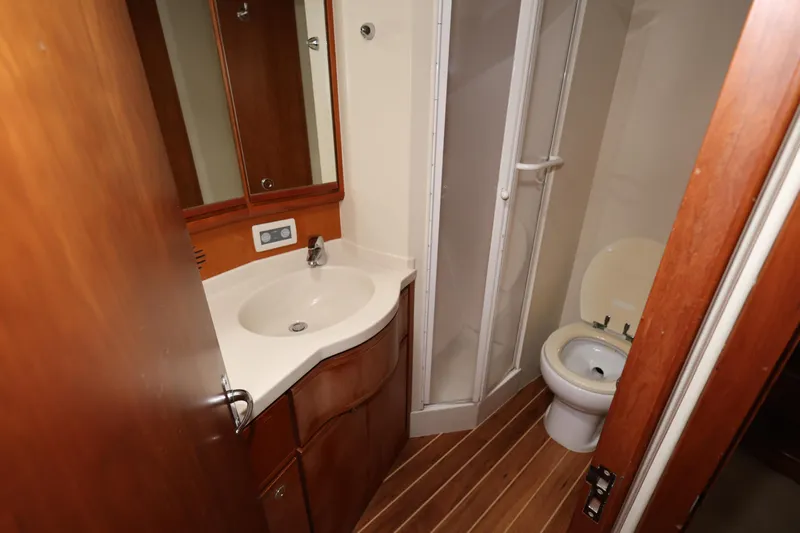  Yacht Photos Pics 2012 Bertram 511 yacht bathroom with sink, toilet, and shower.