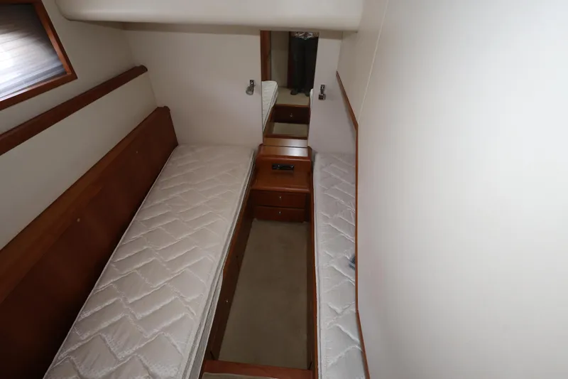  Yacht Photos Pics 2012 Bertram 511 cabin interior with twin beds and wooden furnishings.