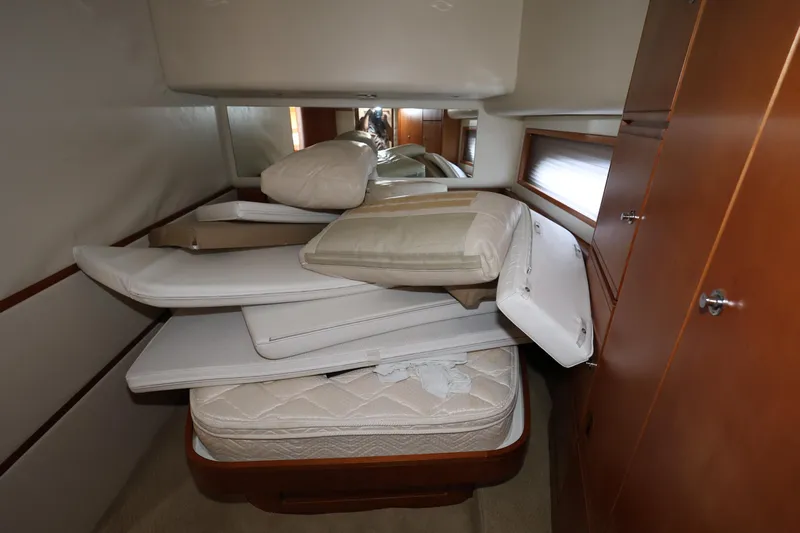  Yacht Photos Pics Interior cabin of 2012 Bertram 511 yacht with stacked mattresses and cushions.