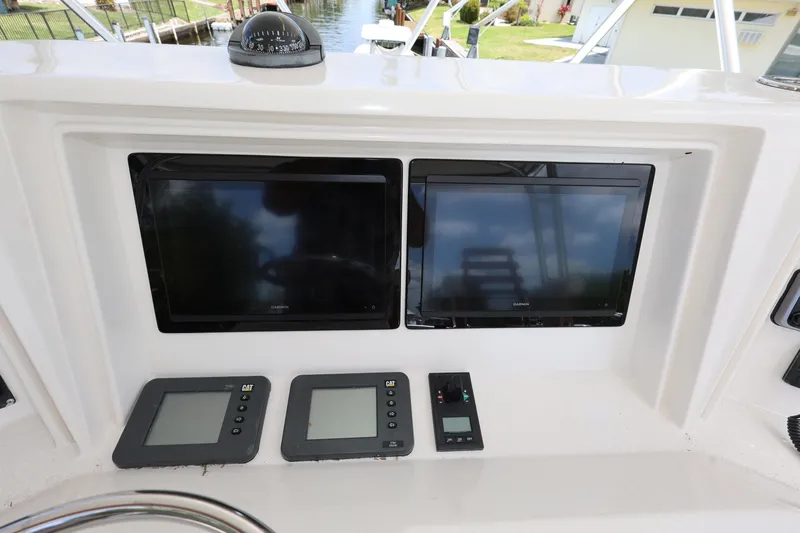  Yacht Photos Pics Control panel of a 2012 Bertram 511 yacht with navigation screens and instruments.