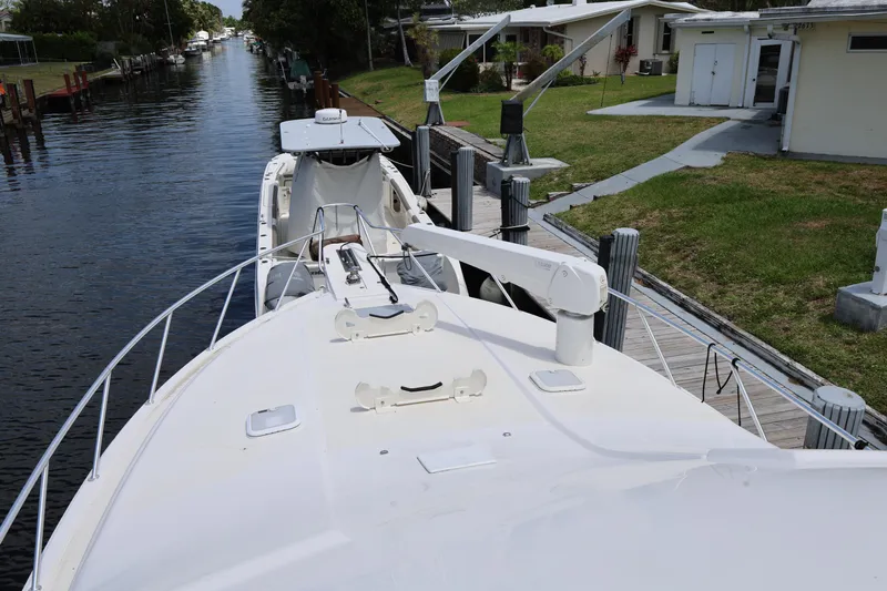  Yacht Photos Pics 2012 Bertram 511 yacht docked by a canal, showcasing its sleek deck design.