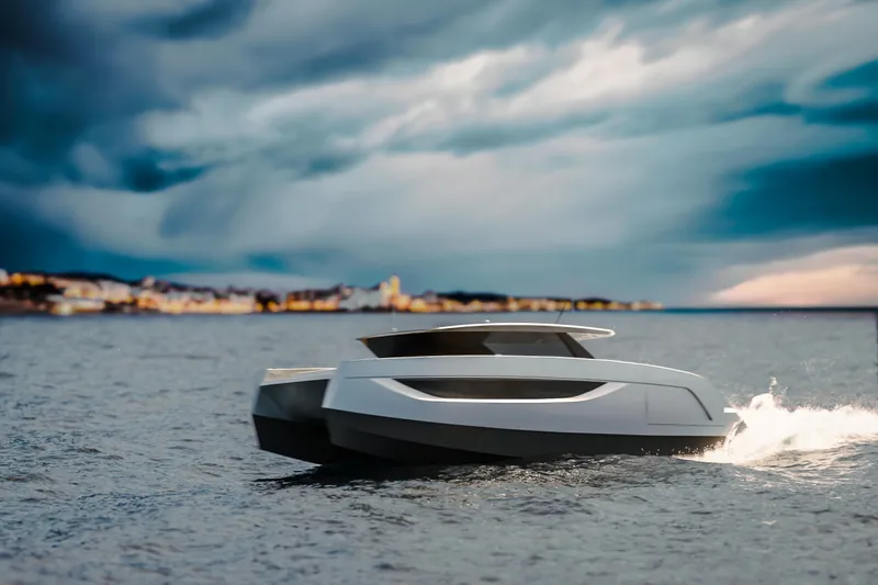  Yacht Photos Pics Futuristic Sunreef Ultima 44 yacht cruising on open water under dramatic skies, 2026 model.