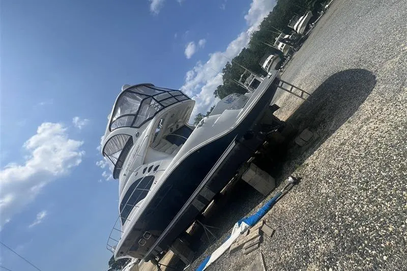  Yacht Photos Pics 2007 Sea Ray 52 Sedan Bridge yacht on dry dock under a clear blue sky.