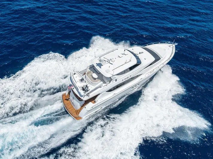 Griffin Yacht Photos Pics Aerial view of 2013 Hatteras 80 Motor Yacht cruising on open blue sea.