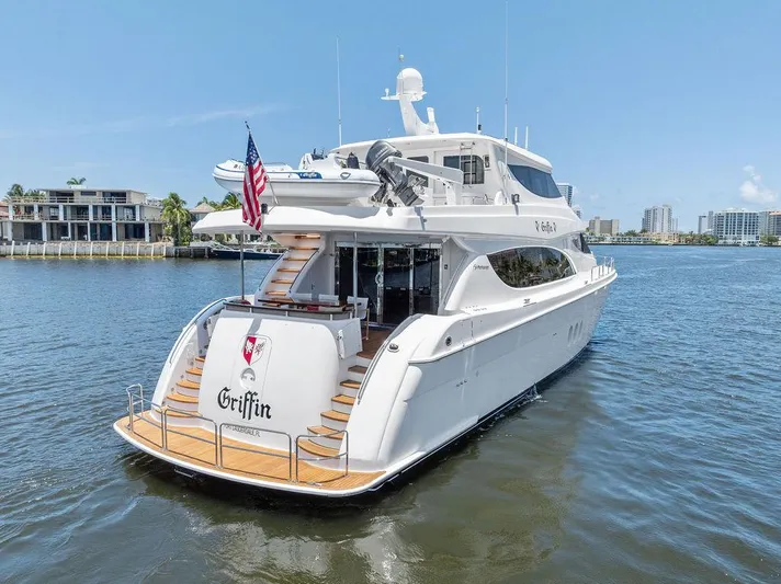Griffin Yacht Photos Pics 2013 Hatteras 80 Motor Yacht on water, rear view, sunny day, American flag displayed.