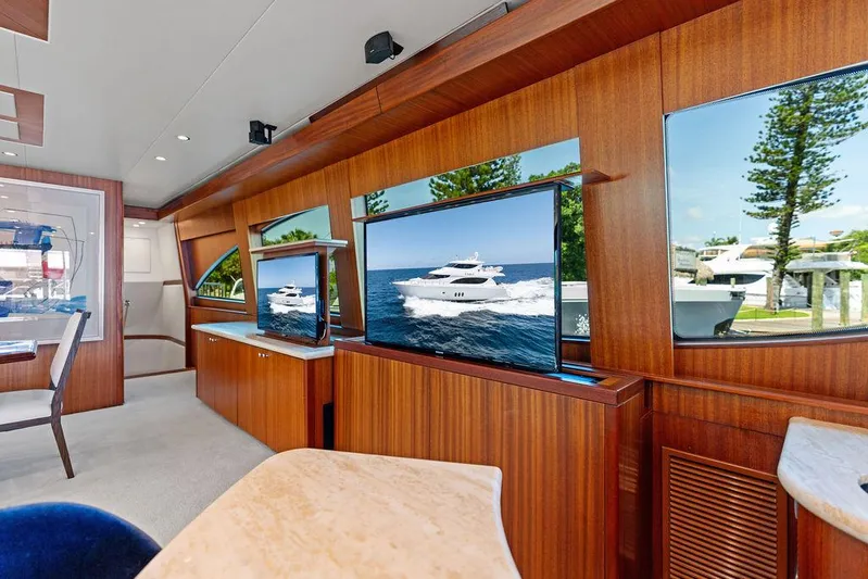Griffin Yacht Photos Pics Luxurious interior of 2013 Hatteras 80 Motor Yacht with wood paneling and large windows.