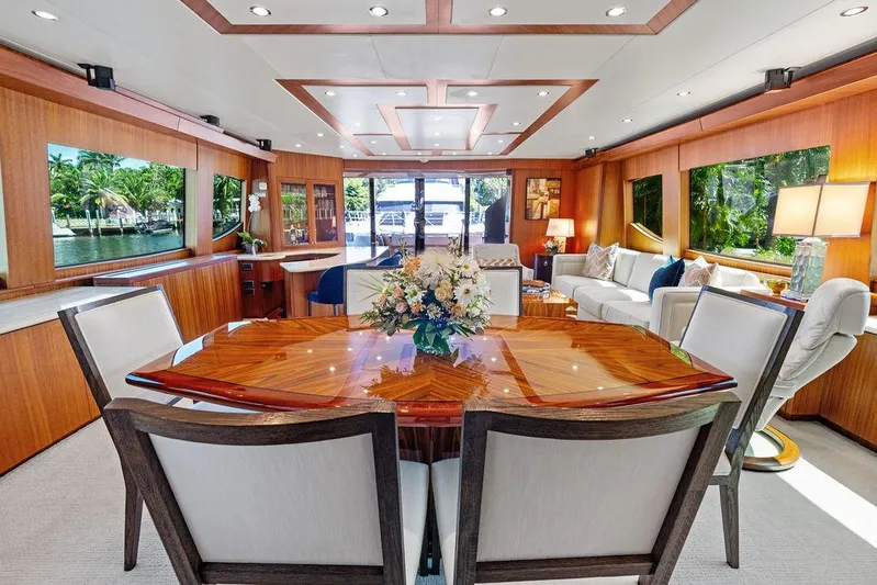 Griffin Yacht Photos Pics Luxurious interior of 2013 Hatteras 80 Motor Yacht with elegant dining area and plush seating.
