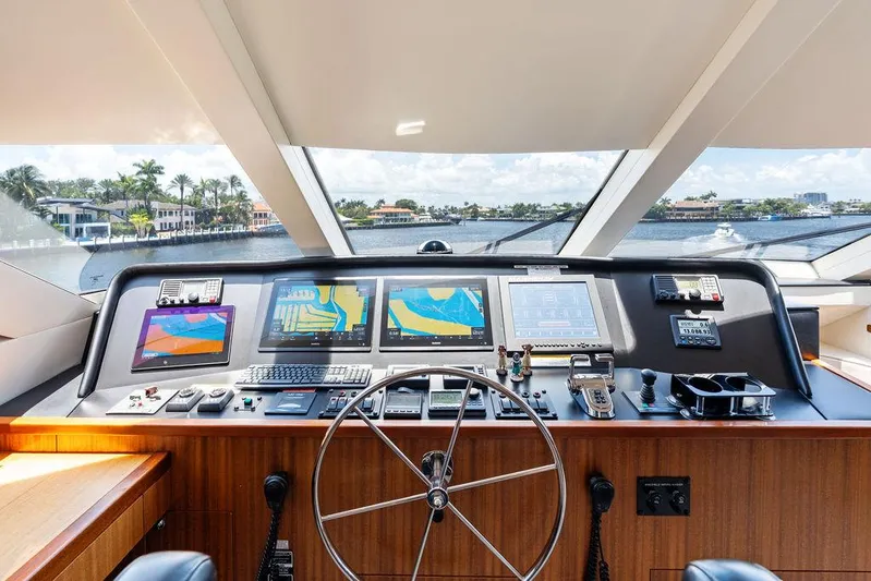Griffin Yacht Photos Pics Helm of 2013 Hatteras 80 Motor Yacht with navigation screens and steering wheel.