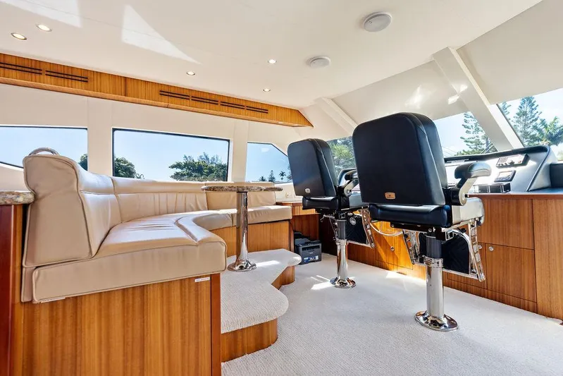 Griffin Yacht Photos Pics Luxurious interior of 2013 Hatteras 80 Motor Yacht with plush seating and helm chairs.
