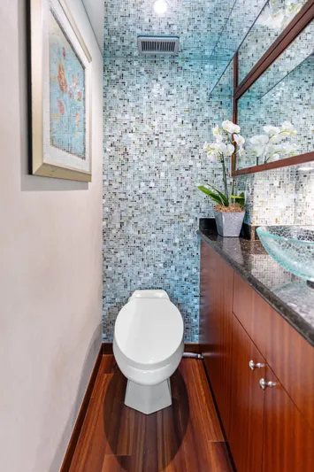 Griffin Yacht Photos Pics Luxurious bathroom on 2013 Hatteras 80 Motor Yacht with mosaic tiles and modern fixtures.