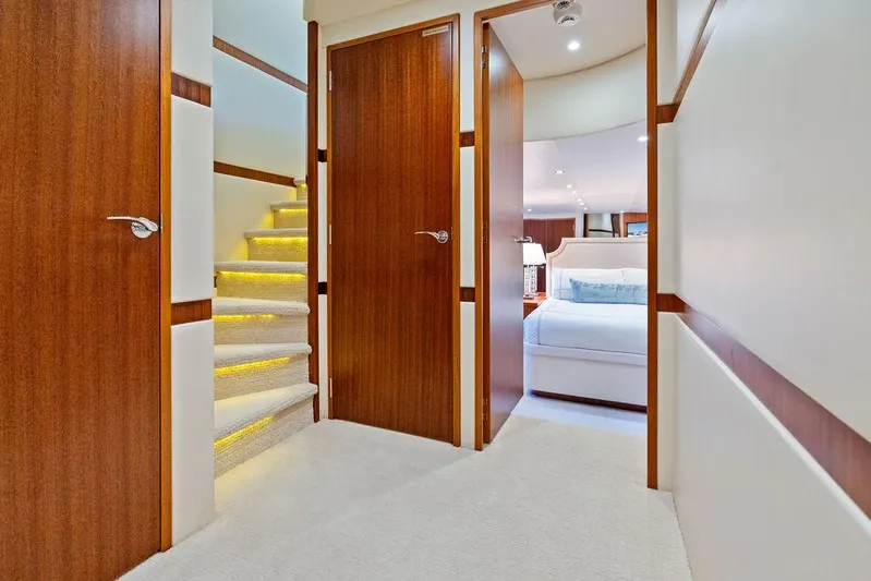 Griffin Yacht Photos Pics Luxurious interior of 2013 Hatteras 80 Motor Yacht with elegant wood finishes and cozy bedroom.