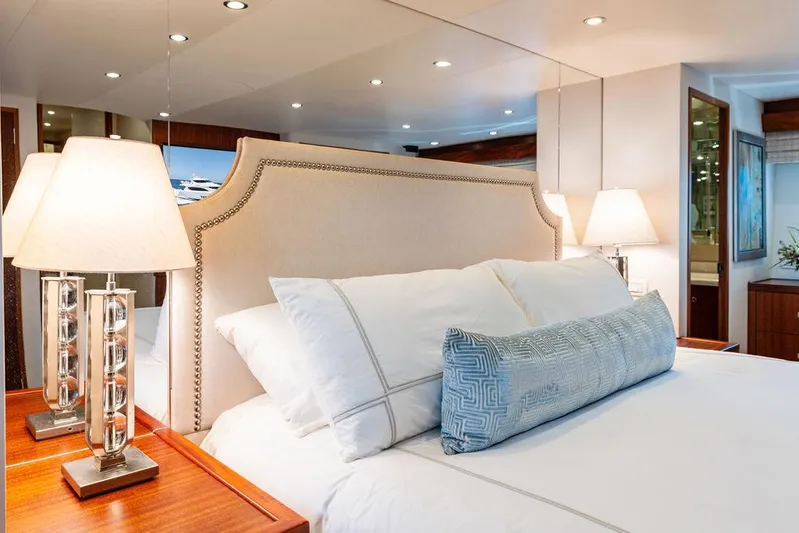 Griffin Yacht Photos Pics Luxurious bedroom interior of 2013 Hatteras 80 Motor Yacht with elegant bedding and lamps.