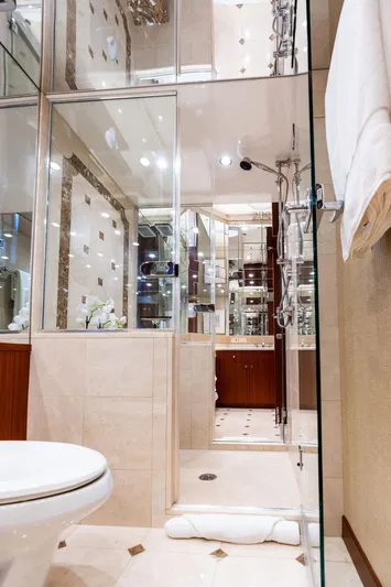 Griffin Yacht Photos Pics Luxurious bathroom in 2013 Hatteras 80 Motor Yacht with elegant fixtures and glass shower.