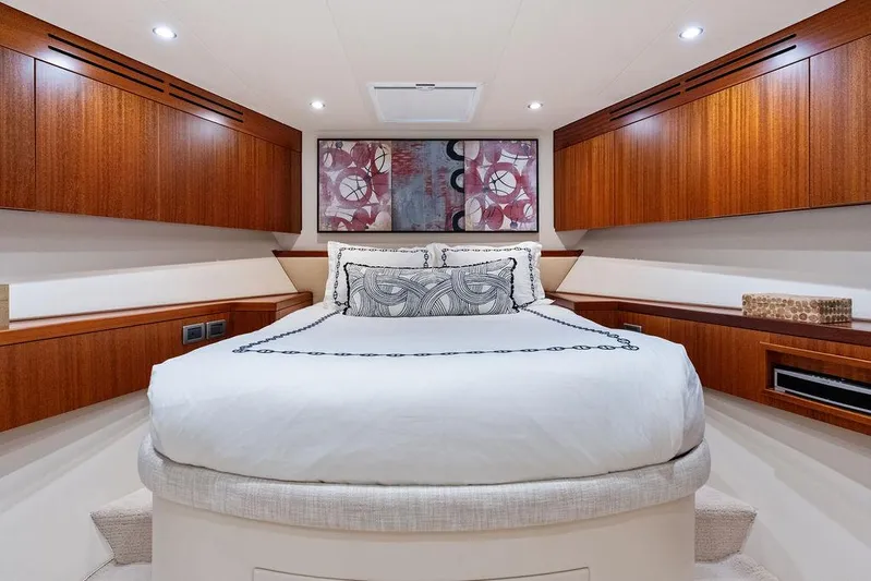 Griffin Yacht Photos Pics Luxurious bedroom interior of 2013 Hatteras 80 Motor Yacht with elegant wood cabinetry.