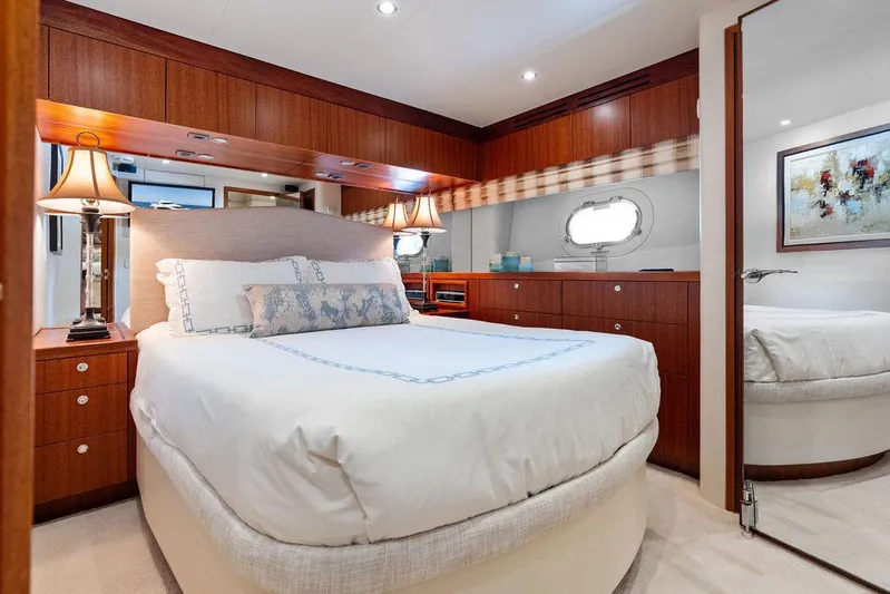 Griffin Yacht Photos Pics Luxurious bedroom interior of 2013 Hatteras 80 Motor Yacht with elegant wood finishes.