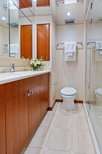 Griffin Yacht Photos Pics Luxurious bathroom in 2013 Hatteras 80 Motor Yacht with elegant wood cabinetry.