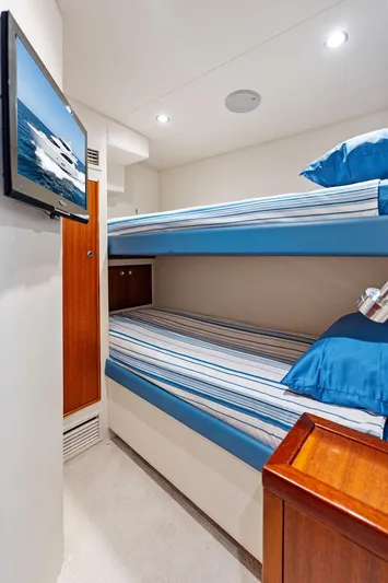 Griffin Yacht Photos Pics Bunk beds in 2013 Hatteras 80 Motor Yacht cabin with TV and striped bedding.