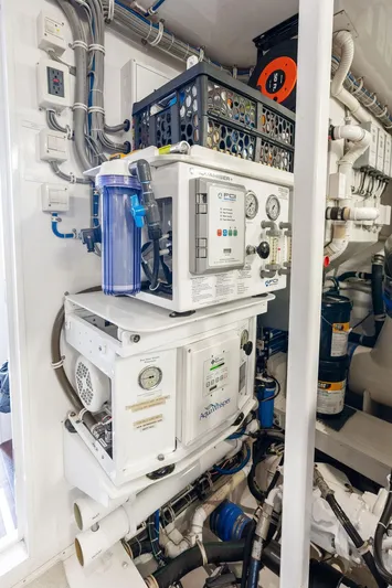 Griffin Yacht Photos Pics Engine room of 2013 Hatteras 80 Motor Yacht with water filtration system and control panels.