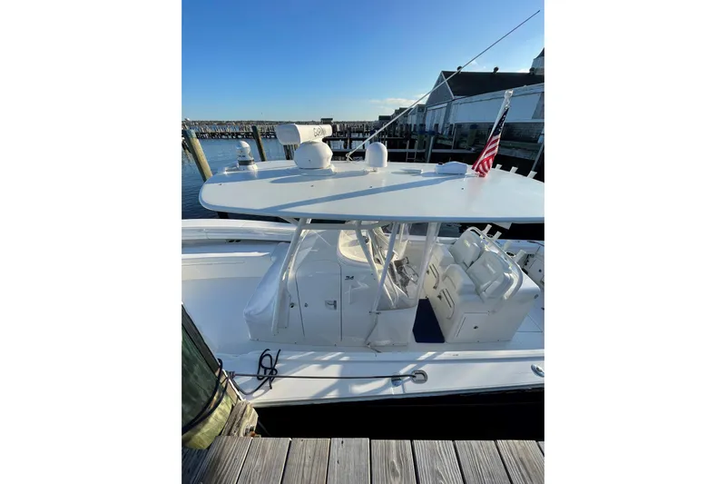 Flag Blue Yacht Photos Pics 2018 Regulator 34SS boat docked, featuring a sleek design and American flag.