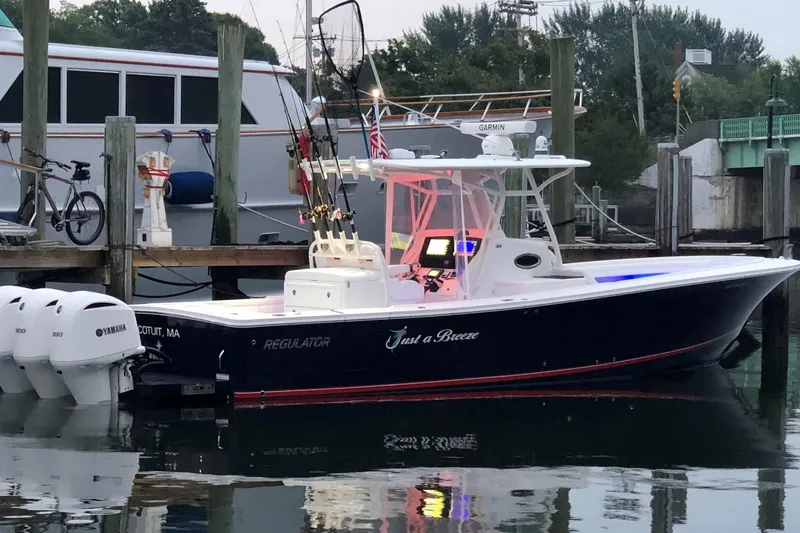 Flag Blue Yacht Photos Pics 2018 Regulator 34SS boat docked, featuring Yamaha engines and fishing equipment.