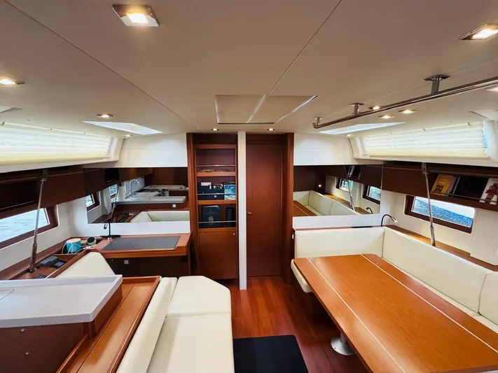 Flight Risk Yacht Photos Pics Interior of 2020 Beneteau Oceanis 51.1 yacht, featuring elegant wood finishes and spacious seating.