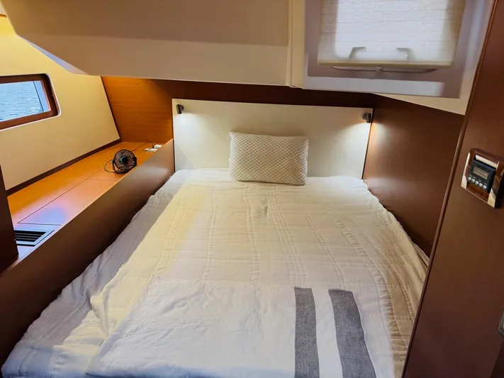 Flight Risk Yacht Photos Pics Cozy cabin interior of 2020 Beneteau Oceanis 51.1 yacht with comfortable bed and modern design.