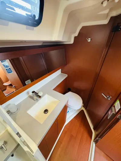 Flight Risk Yacht Photos Pics Beneteau Oceanis 51.1 2020 yacht bathroom with modern sink and wooden cabinetry.