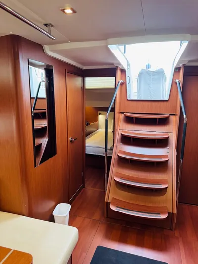 Flight Risk Yacht Photos Pics Interior of 2020 Beneteau Oceanis 51.1 yacht with wooden stairs and cozy cabin.