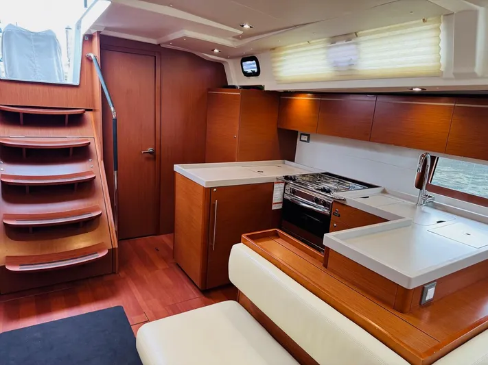 Flight Risk Yacht Photos Pics Interior of 2020 Beneteau Oceanis 51.1 yacht, featuring modern kitchen and wooden finishes.
