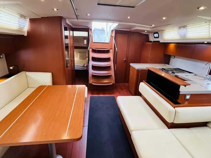 Flight Risk Yacht Photos Pics Luxurious interior of 2020 Beneteau Oceanis 51.1 yacht with modern kitchen and seating area.