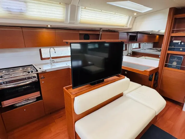 Flight Risk Yacht Photos Pics Luxurious interior of 2020 Beneteau Oceanis 51.1 yacht with modern kitchen and seating area.