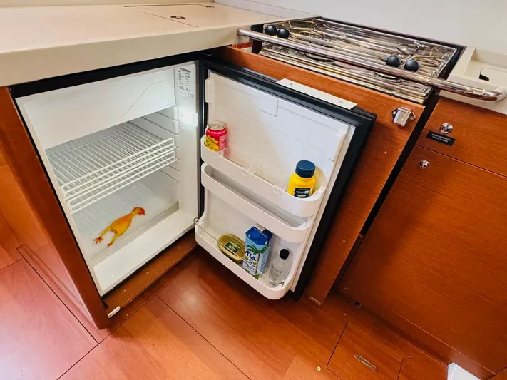 Flight Risk Yacht Photos Pics Open fridge in Beneteau Oceanis 51.1 yacht kitchen, containing condiments and a rubber chicken.