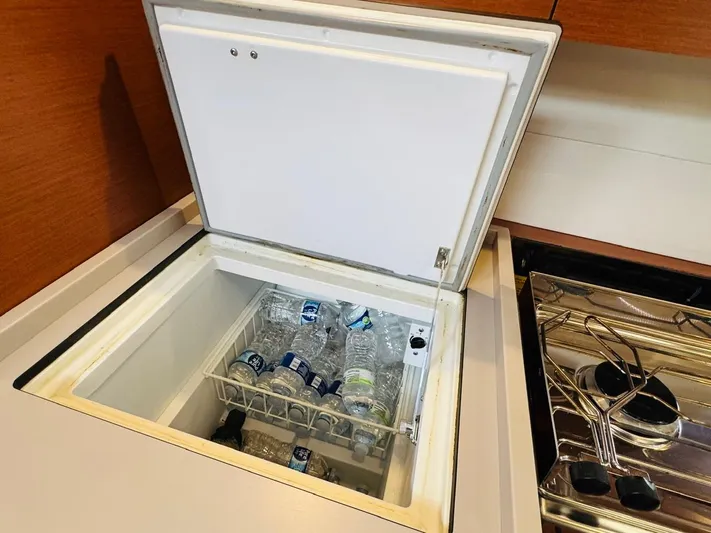 Flight Risk Yacht Photos Pics Open fridge with water bottles inside on Beneteau Oceanis 51.1 yacht, 2020 model.