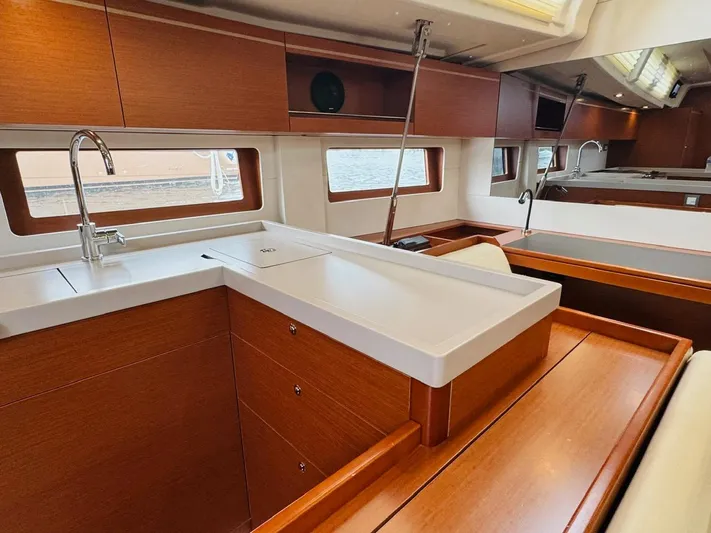 Flight Risk Yacht Photos Pics Interior of 2020 Beneteau Oceanis 51.1 yacht, featuring modern kitchen with wood cabinetry.