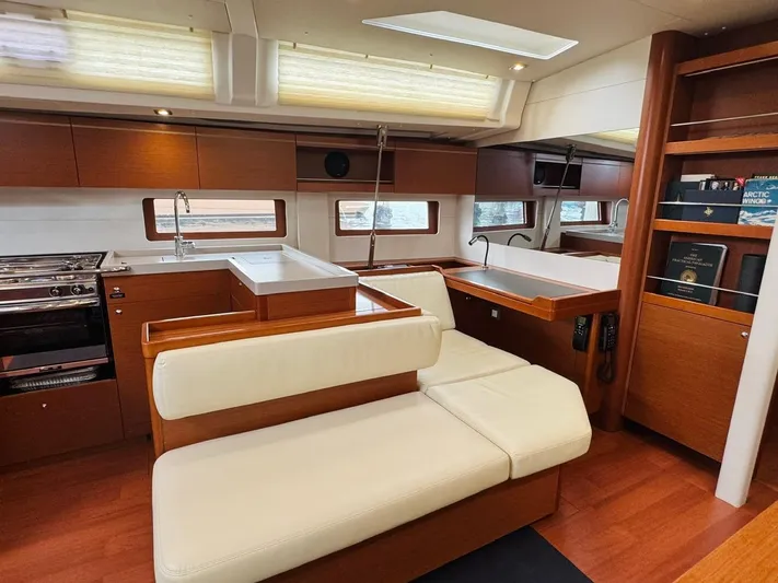 Flight Risk Yacht Photos Pics Luxurious interior of 2020 Beneteau Oceanis 51.1 yacht with modern kitchen and seating area.
